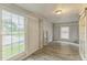 Sun-filled living room features wood flooring, large windows, and neutral paint, creating a warm and inviting space at 500 Cokey Rd, Rocky Mount, NC 27801