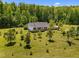 Aerial view of a white house with a spacious lawn surrounded by trees at 5013 W Pool Rd, Rougemont, NC 27572