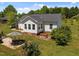 Aerial view of the backyard with patio, hot tub, and lush green lawn at 5013 W Pool Rd, Rougemont, NC 27572