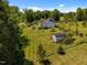 Beautiful, verdant backyard featuring a large grassy area, mature trees, and a small shed at 5013 W Pool Rd, Rougemont, NC 27572
