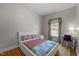 Cozy bedroom featuring hardwood floors, a large window, and neutral tones for a relaxing atmosphere at 5013 W Pool Rd, Rougemont, NC 27572