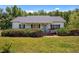 Charming single story home features a cozy front porch and mature landscaping at 5013 W Pool Rd, Rougemont, NC 27572