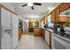Traditional eat-in kitchen featuring oak cabinetry, modern appliances, and an adjacent dining area perfect for Gathering meals at 5013 W Pool Rd, Rougemont, NC 27572