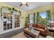 Sunlit living room featuring french doors, a comfortable sofa, and an abundance of natural light at 5013 W Pool Rd, Rougemont, NC 27572