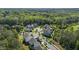 Aerial view highlights a residential community with a wooded backdrop and well-maintained streets at 5145 Landguard Dr, Raleigh, NC 27613