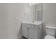 Clean and modern bathroom featuring a vanity with storage, a mirror, and a toilet with neutral wall paint at 5145 Landguard Dr, Raleigh, NC 27613