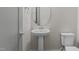 Powder room features pedestal sink, modern fixtures, and neutral color palette at 5145 Landguard Dr, Raleigh, NC 27613