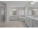 Bright bathroom featuring double vanities, a soaking tub and plantation shutters at 5145 Landguard Dr, Raleigh, NC 27613