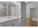 Bright bathroom featuring a double vanity, a large mirror and a combination shower and tub with tile surround at 5145 Landguard Dr, Raleigh, NC 27613