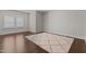 Bedroom featuring hard wood floors, a textured rug and lots of natural light at 5145 Landguard Dr, Raleigh, NC 27613