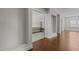 Hallway leading to primary bedroom suite with hardwood floors at 5145 Landguard Dr, Raleigh, NC 27613