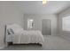 Bedroom with plush bedding, large windows, and ensuite bathroom access at 5145 Landguard Dr, Raleigh, NC 27613