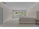 Spacious bedroom featuring plush carpet, natural light and a tufted headboard at 5145 Landguard Dr, Raleigh, NC 27613