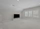 Bonus room featuring a modern entertainment setup, carpet flooring, and shuttered windows that allow natural light to filter through at 5145 Landguard Dr, Raleigh, NC 27613