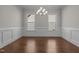 Spacious dining room boasts elegant trim, hardwood floors, and abundant natural light at 5145 Landguard Dr, Raleigh, NC 27613