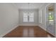 Formal dining room with elegant lighting, hardwood floors, and natural light at 5145 Landguard Dr, Raleigh, NC 27613