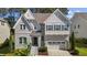 Charming home with a painted brick facade, a manicured front yard, and an attached two-car garage at 5145 Landguard Dr, Raleigh, NC 27613