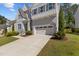 Beautiful home with a long driveway leading to an attached two-car garage and landscaped front yard at 5145 Landguard Dr, Raleigh, NC 27613