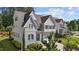 Beautiful two-story home with a manicured lawn and lush landscaping, showcasing its elegant architectural details at 5145 Landguard Dr, Raleigh, NC 27613