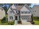 Elegant two-story home with a manicured lawn and a convenient two-car garage at 5145 Landguard Dr, Raleigh, NC 27613
