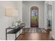 Inviting foyer features hardwood floors, a console table, and a view of the arched front door at 5145 Landguard Dr, Raleigh, NC 27613