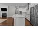 Modern kitchen featuring a large island with quartz countertops, stainless steel appliances, and an open layout at 5145 Landguard Dr, Raleigh, NC 27613