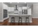 Bright kitchen with a large center island, stainless steel appliances, and white cabinetry at 5145 Landguard Dr, Raleigh, NC 27613