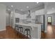 Bright kitchen featuring white cabinets, a large center island with seating, and stainless steel appliances at 5145 Landguard Dr, Raleigh, NC 27613