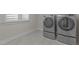 Modern laundry room with new appliances and tile flooring at 5145 Landguard Dr, Raleigh, NC 27613