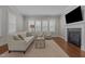 Inviting living room featuring a fireplace, comfortable seating, and natural lighting at 5145 Landguard Dr, Raleigh, NC 27613