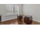 Bright home office with custom desk, hardwood floors, and window shutters at 5145 Landguard Dr, Raleigh, NC 27613