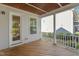 Relaxing porch with wood floors and a view of the landscaped backyard at 5145 Landguard Dr, Raleigh, NC 27613