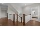 Hardwood staircase with white railings, leading to the upper level at 5145 Landguard Dr, Raleigh, NC 27613