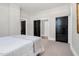 Neutral bedroom showcasing soft carpeting and classic black interior doors at 5299 Momeyer Way, Nashville, NC 27856