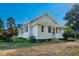 Charming home with white siding, black shutters, and manicured landscaping at 5299 Momeyer Way, Nashville, NC 27856