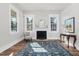 Sunlit living room with a fireplace, large windows, stylish furniture, and a patterned area rug at 5299 Momeyer Way, Nashville, NC 27856