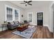 Bright living room with stylish rug, gray sofa, ceiling fan, and large windows at 5299 Momeyer Way, Nashville, NC 27856