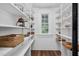 Well-organized pantry with ample shelving and a bright window at 5299 Momeyer Way, Nashville, NC 27856
