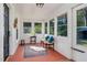 Cozy sunroom with paneled walls, a rustic bench, and lots of natural light at 5299 Momeyer Way, Nashville, NC 27856
