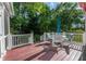 A relaxing deck area featuring wooden flooring, white railings, and outdoor furniture at 5417 Harrington Grove Dr, Raleigh, NC 27613