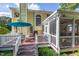 View of the yellow house with its expansive back deck and screened-in porch, perfect for outdoor entertaining at 5417 Harrington Grove Dr, Raleigh, NC 27613