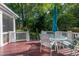 A relaxing deck area featuring wooden flooring, white railings, and outdoor furniture at 5417 Harrington Grove Dr, Raleigh, NC 27613