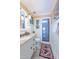 Well-lit bathroom featuring a granite countertop, white vanity, wainscoting, and a walk-in shower at 5417 Harrington Grove Dr, Raleigh, NC 27613