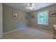A cozy, carpeted bedroom featuring natural light from the window and a ceiling fan at 5417 Harrington Grove Dr, Raleigh, NC 27613