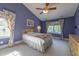 Cozy bedroom featuring light carpet, vaulted ceiling, and abundant natural light at 5417 Harrington Grove Dr, Raleigh, NC 27613