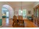 Bright dining area with hardwood floors, large windows, and an antique cabinet at 5417 Harrington Grove Dr, Raleigh, NC 27613