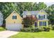 Charming yellow two-story home featuring blue shutters and a well-manicured front lawn at 5417 Harrington Grove Dr, Raleigh, NC 27613