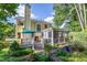A bright yellow home featuring a deck, a screened porch, and lush landscaping at 5417 Harrington Grove Dr, Raleigh, NC 27613