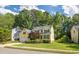 Inviting two-story home with blue shutters, beautiful landscaping, and a well-maintained lawn at 5417 Harrington Grove Dr, Raleigh, NC 27613
