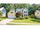 Charming two-story home with a well-manicured lawn, vibrant flowerbeds, and a classic architectural style at 5417 Harrington Grove Dr, Raleigh, NC 27613